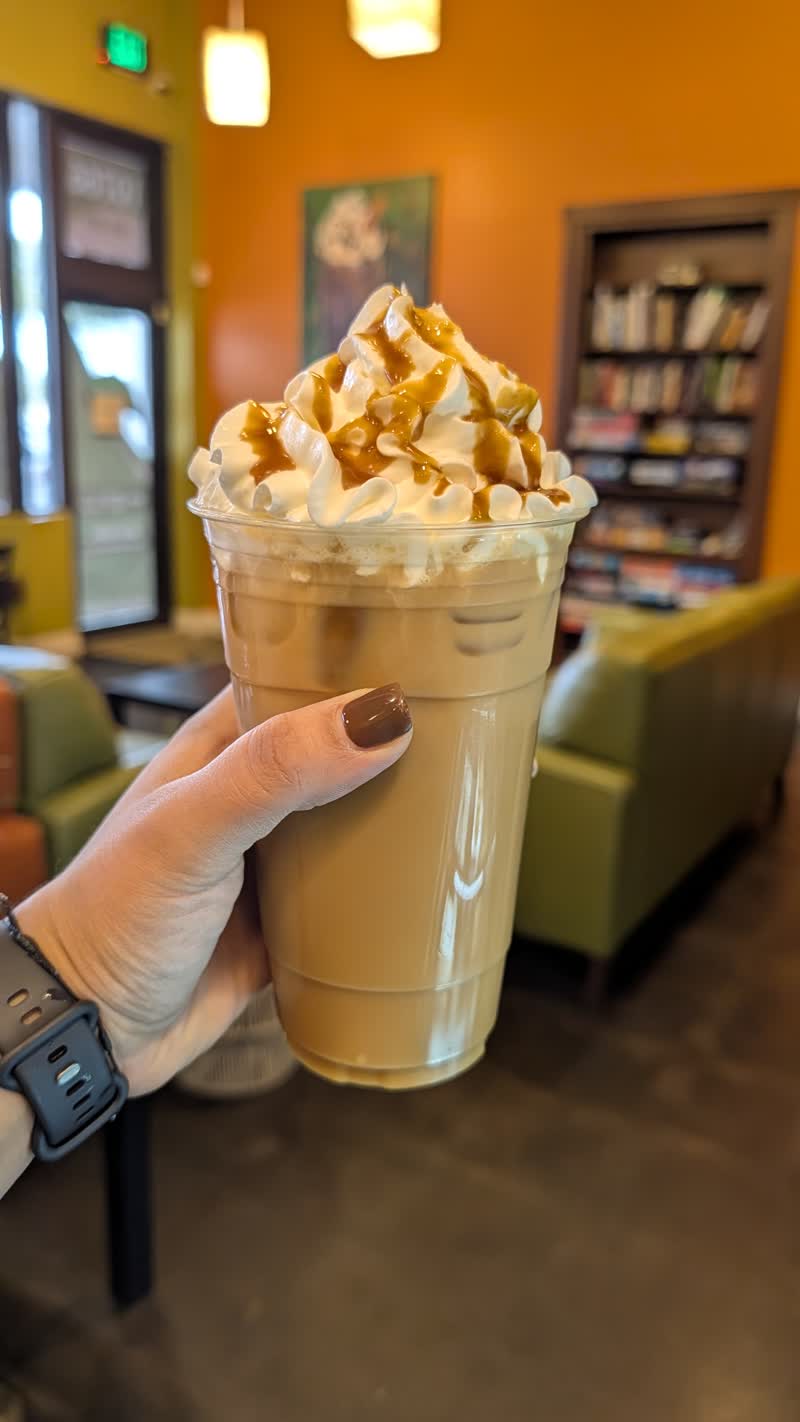 Caramel frappe with the cozy lounge behind at specialTEA